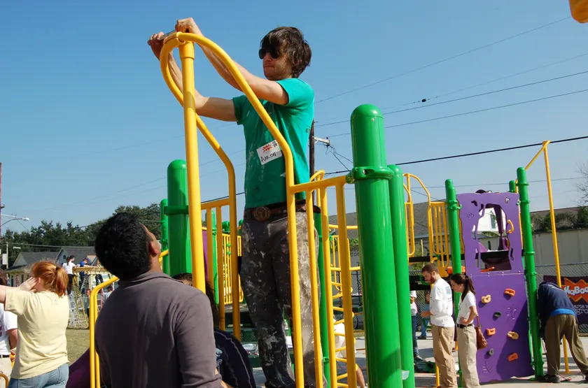 Adults building a playground structure outdoors