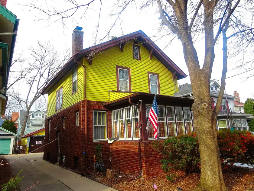 A two-story craftsman house with a wide front porch and no people