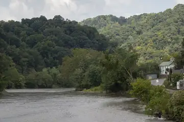 A wide river bending through trees and a small town