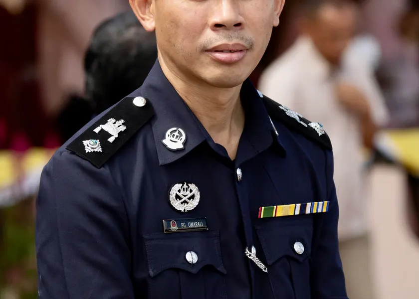A uniformed police officer standing outdoors