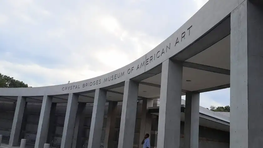The Crystal Bridges Museum of American Art building beside a reflecting pool