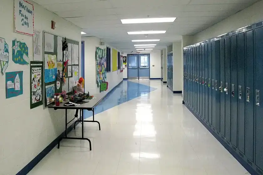 A service member mopping a hallway floor