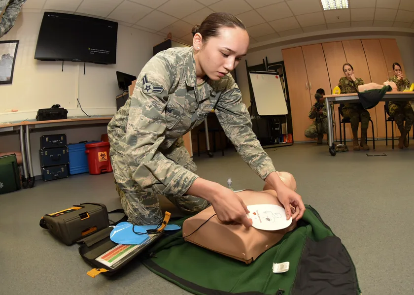 An airman practicing how to place defibrillator pads