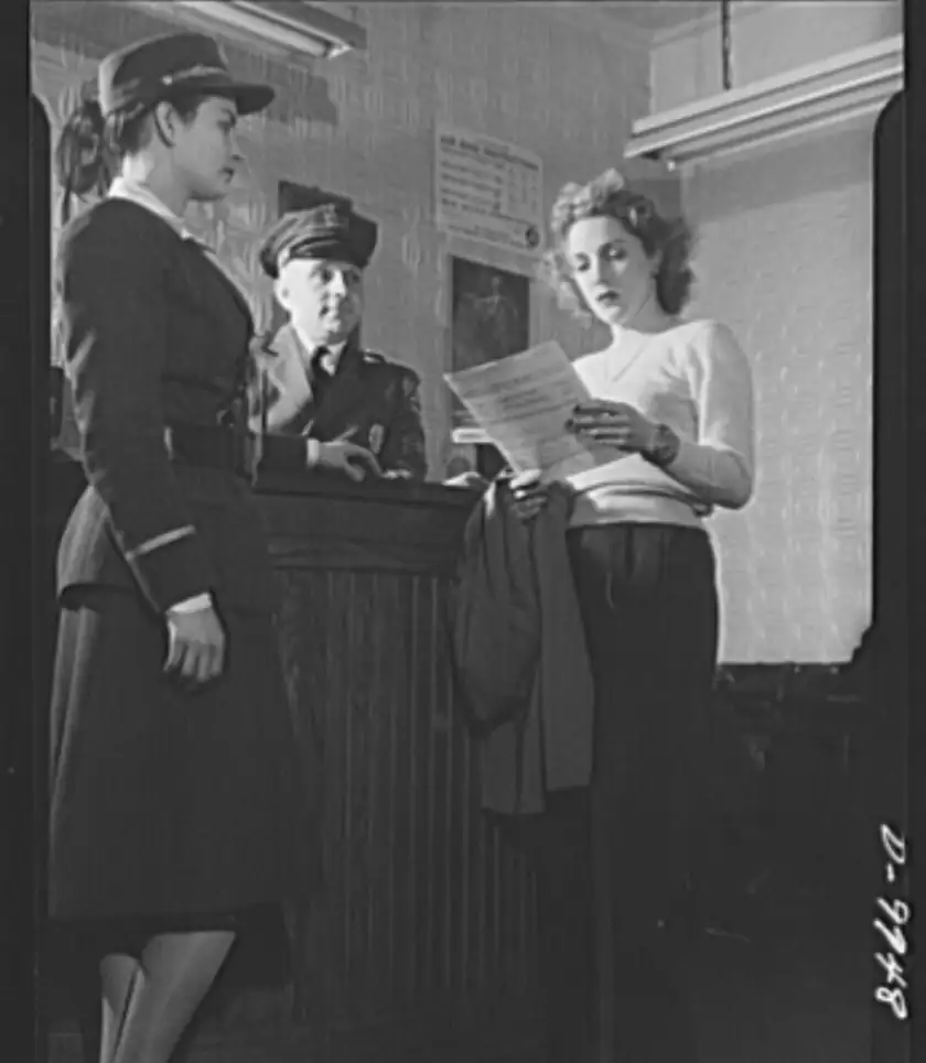 Three adults in an office looking over a printed form