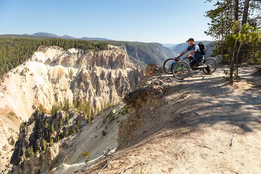 A person in an off-road wheelchair on a rocky overlook