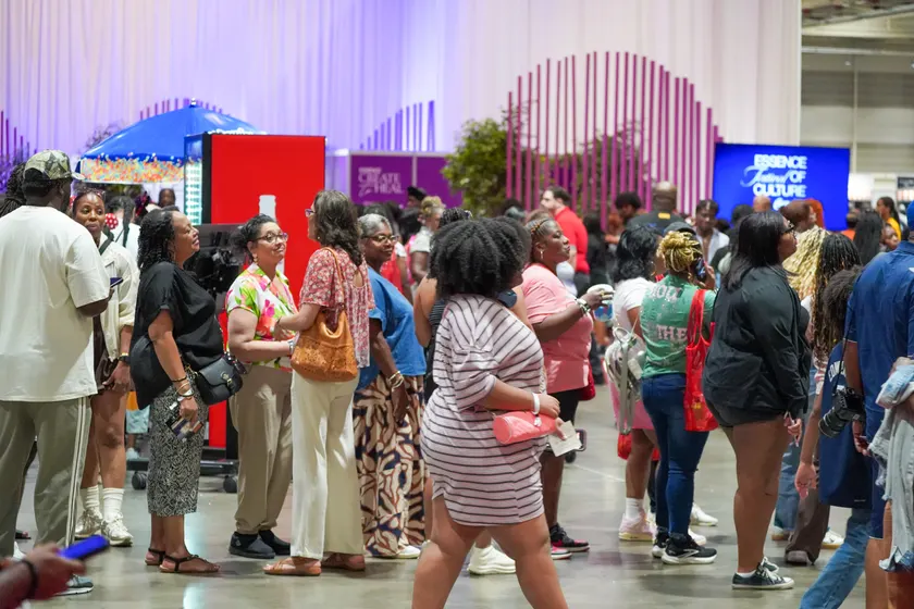 Adults gathered in a crowd at an indoor festival