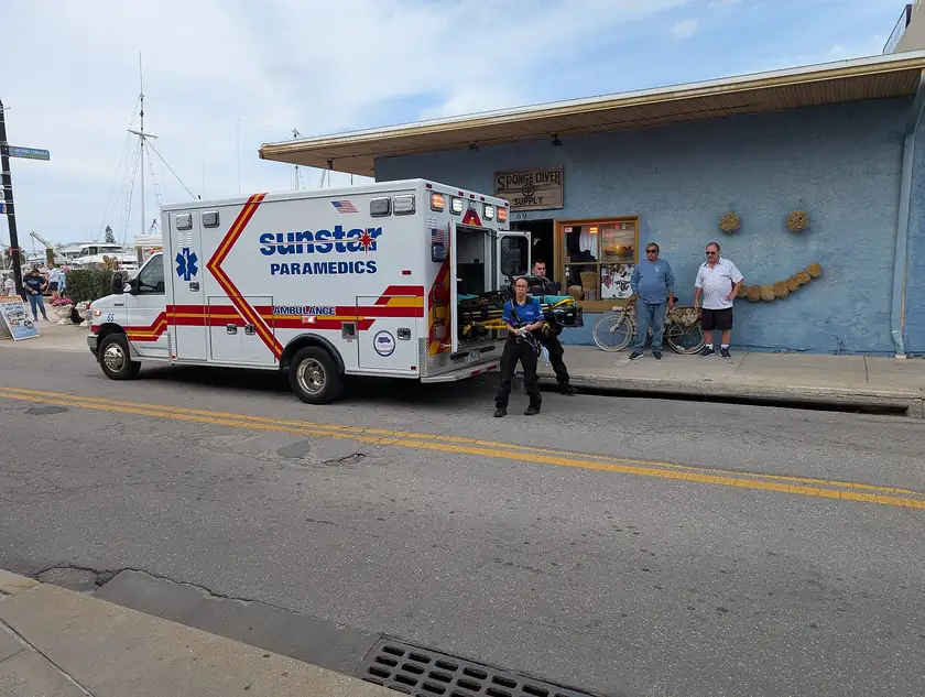 Paramedics standing beside a Sunstar ambulance on a city street