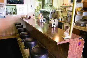 Diner workers standing behind a lunch counter