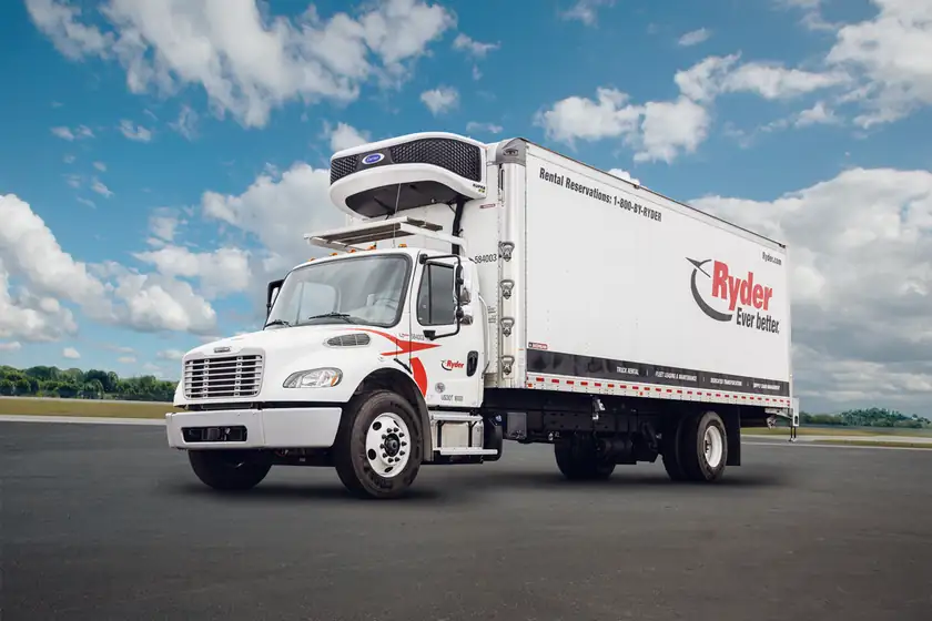 A white refrigerated box truck parked on a street