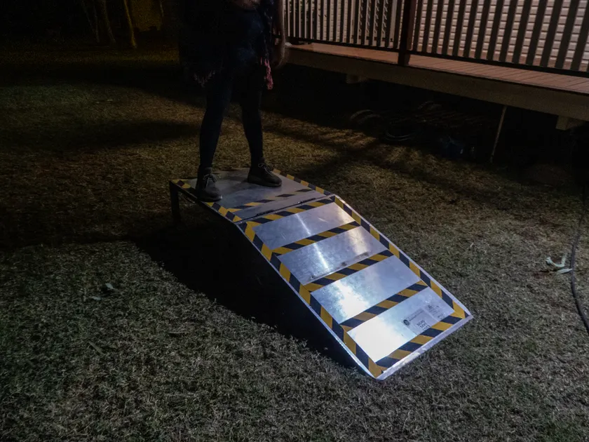 A person standing on an accessible boarding ramp