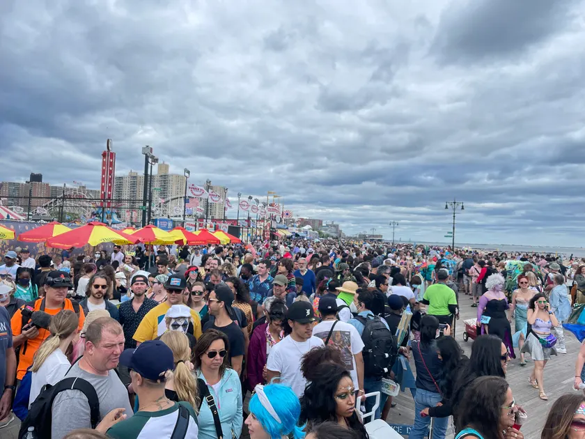 A crowd walking together at an outdoor parade