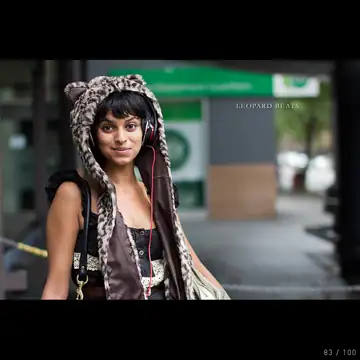A person wearing large headphones, with the face cropped out of the frame