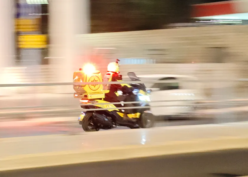 A paramedic riding an emergency scooter