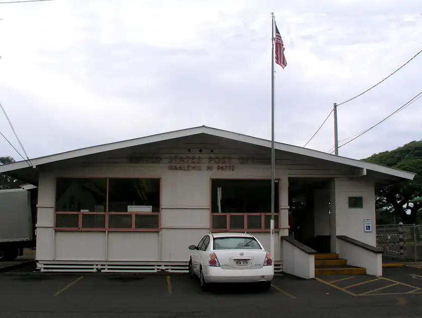 The Naalehu post office, a small building with a flag and no people in the frame