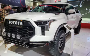 A blue Toyota Tundra pickup parked on pavement, with no people
