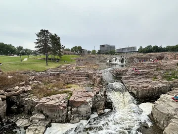 Water flowing over pink quartzite rocks at Falls Park in Sioux Falls