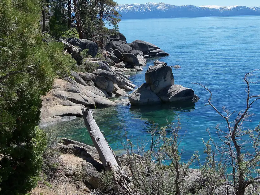 Granite boulders along a clear blue stretch of Lake Tahoe