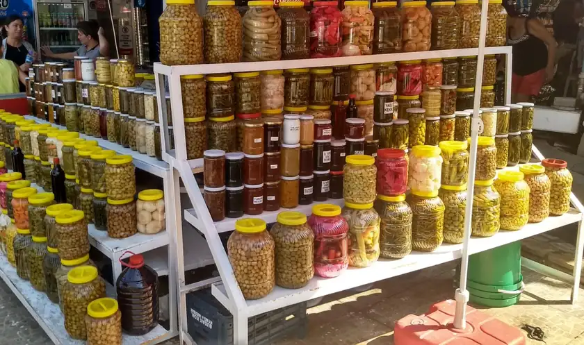 Jars and cans of vegetables and pickles lined up together